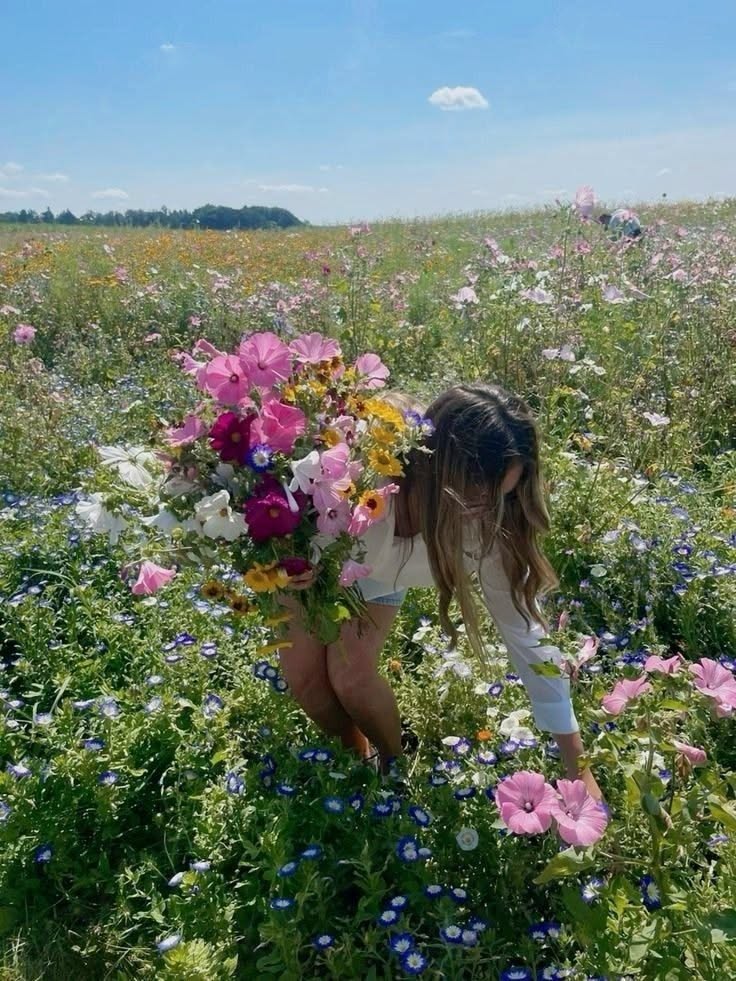 Norwegian Friluftsliv: A girl picking flowers in a lush green meadow.